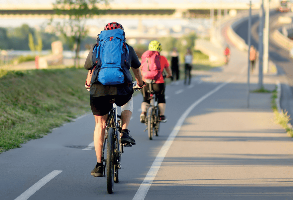 Bicyclists riding down a road coarse path.